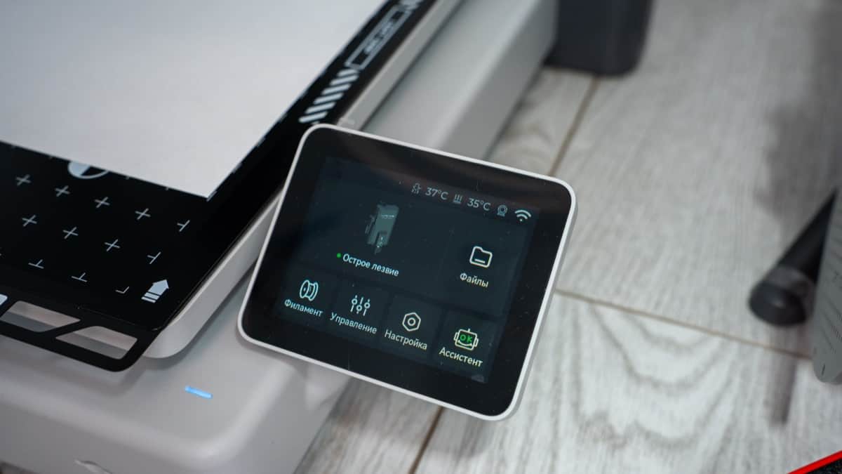 Touchscreen dashboard displaying real-time nozzle temperature, print progress, and speed profiles