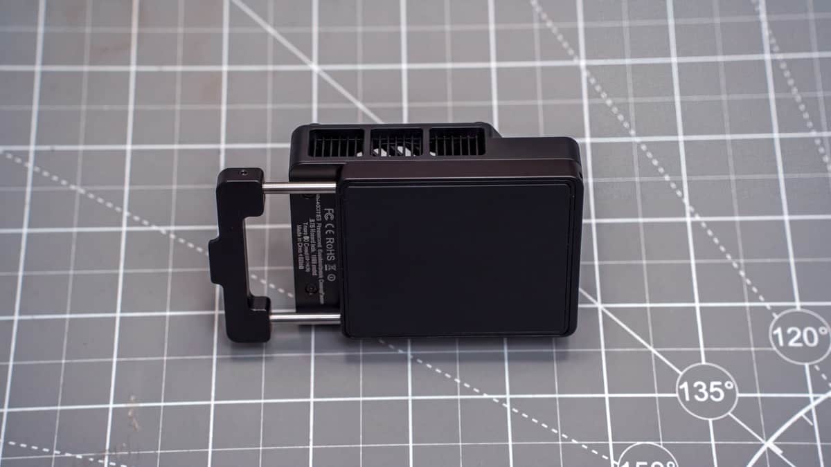 Underside of the cooler showing smooth Peltier contact plate, extended sliding clamp, and FCC/CE markings