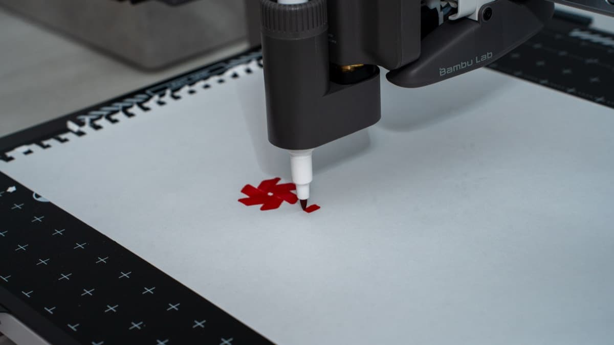 Pen plotting attachment actively sketching vector artwork using a red felt marker