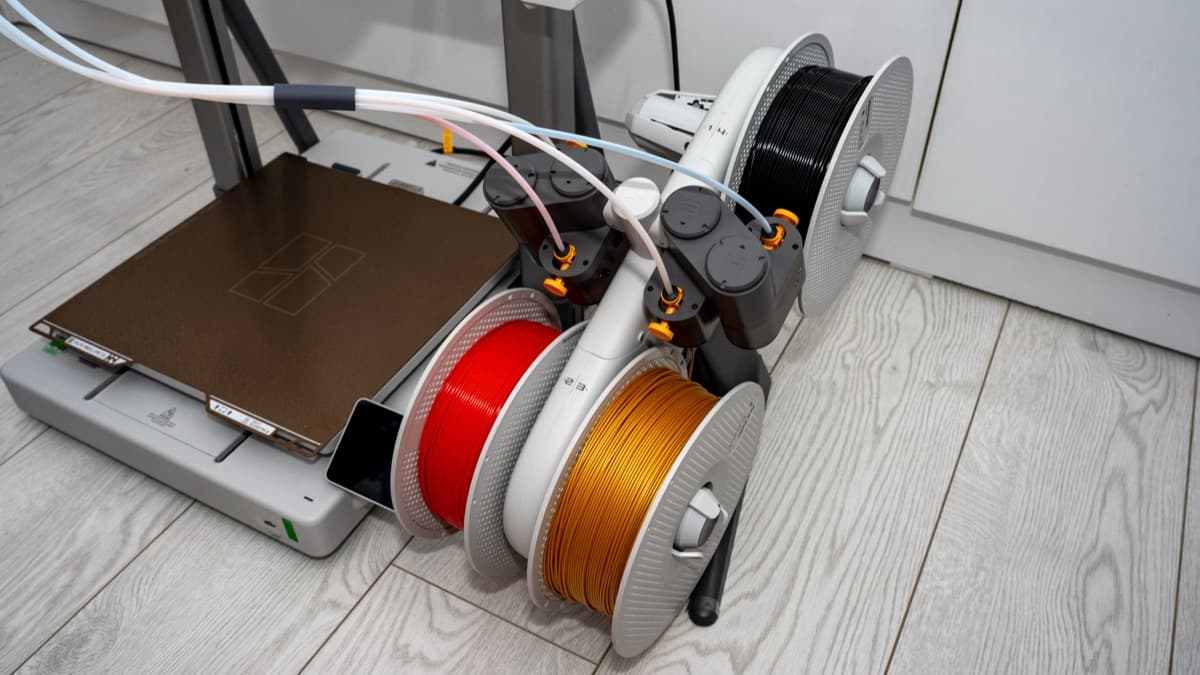 Bambu Lab A2L Combo operating on the floor alongside furniture to accommodate the moving bed