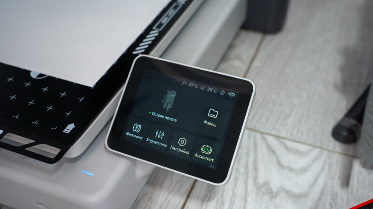 Touchscreen dashboard displaying real-time nozzle temperature, print progress, and speed profiles