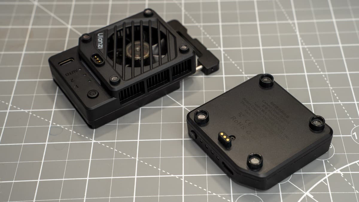Gold-plated spring-loaded pogo pins on the cooler body and magnetic alignment recess on the battery