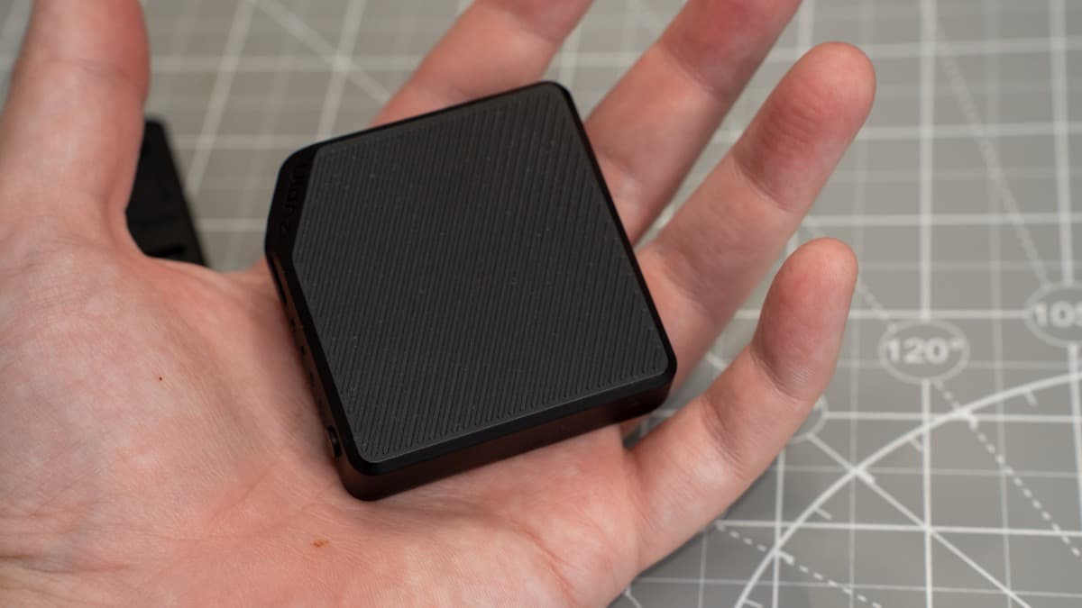 The 3,000mAh magnetic battery pack resting in palm, showcasing ultra-compact scale