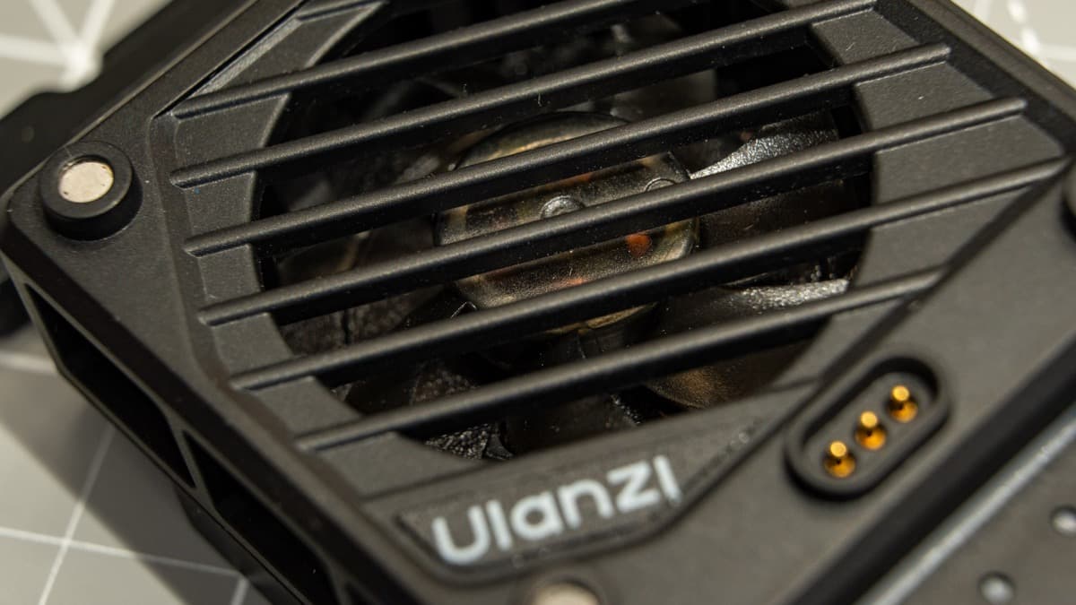 Macro detail of the 5,000 RPM high-speed intake fan and protective diagonal grille