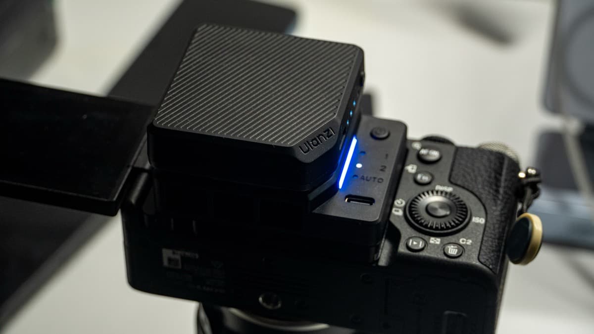 Ulanzi CU01 mounted securely behind the articulated screen of a Sony α7C II, glowing blue LED indicator active