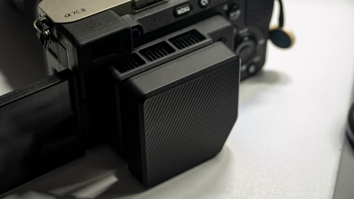 Rear profile angle of the cooler clamped flush against the magnesium rear chassis of the Sony α7C II