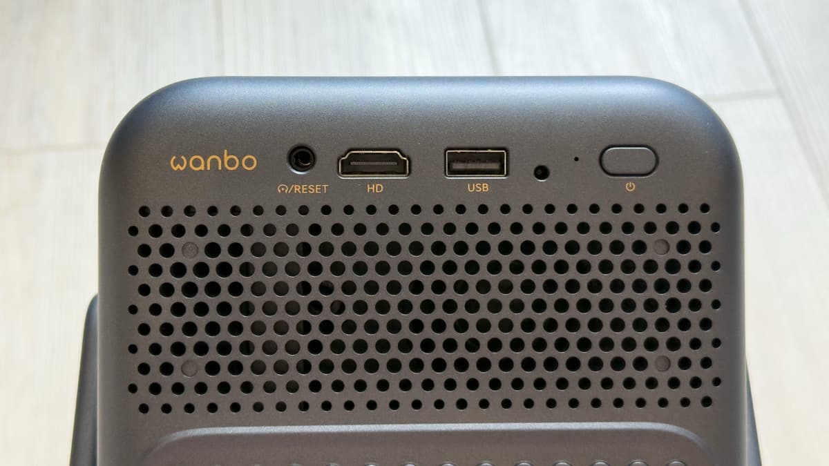 Rear I/O port cluster: 3.5mm audio jack, HDMI 2.0 port, USB-A 2.0 port, IR receiver, and tactile power button