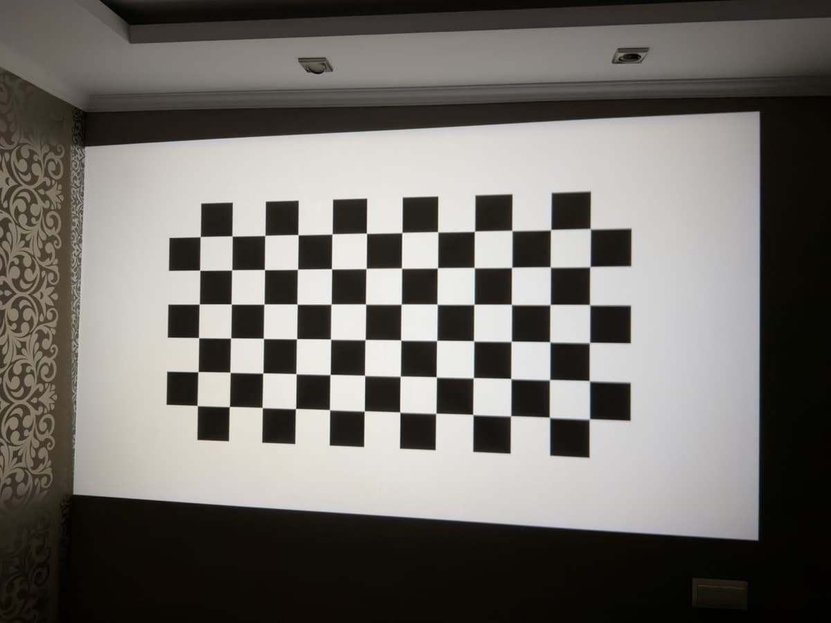 Optical test pattern: high-contrast checkerboard grid evaluating optical flare control and luminance uniformity