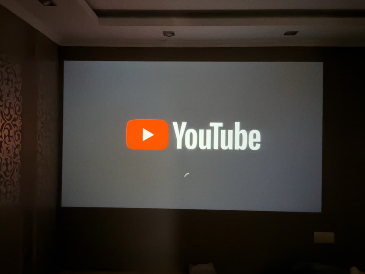 Google TV on Android 14 user interface projected on wall, displaying personalized recommendations and installed streaming apps